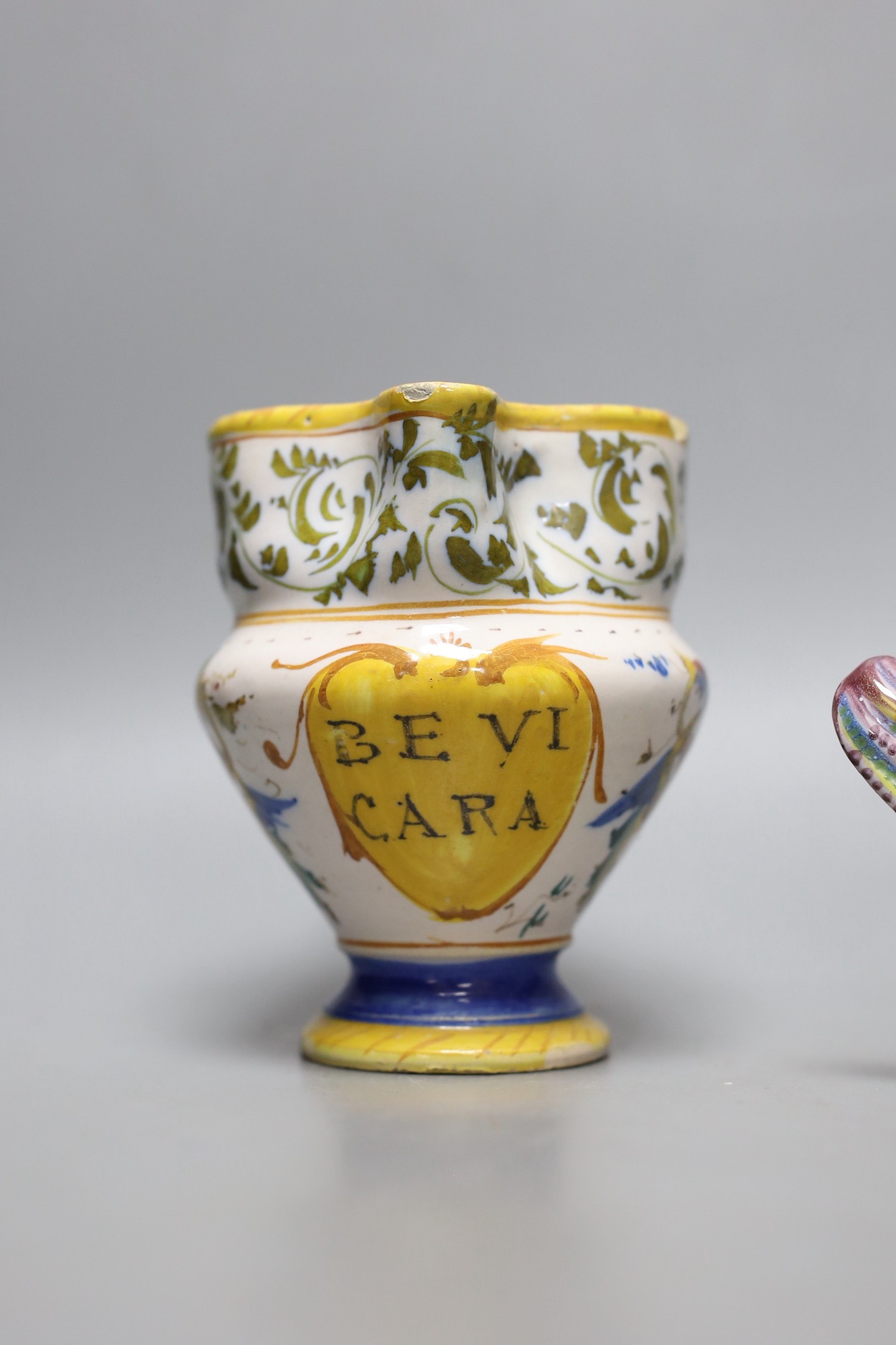 An Italian maiolica pinched beak jug, 12cm tall, and a similar dish